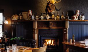 Tables by the fireplace at Clarendon Arms